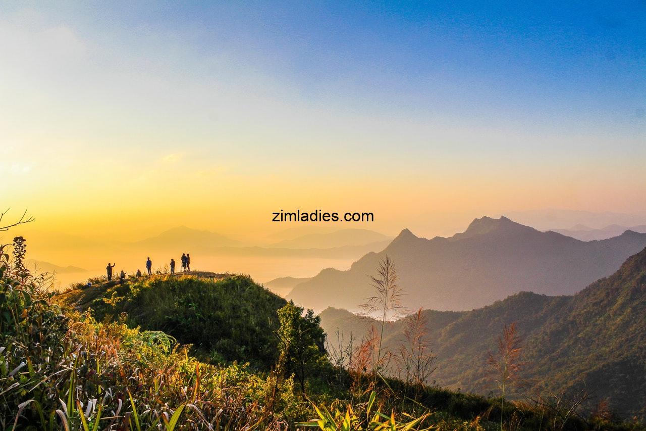 Photo Of People Standing On Top Of Mountain Near Grasses 733162